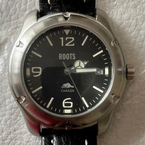 Roots -New watch needs battery  Round black dial with date , luminous dial